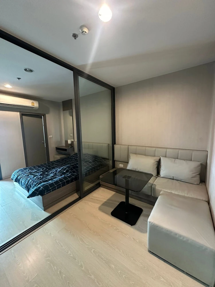For sale: Ideo Tha Phra Interchange. Features sliding doors separating the living room and bedroom, a separate kitchen with balcony access, and built-
