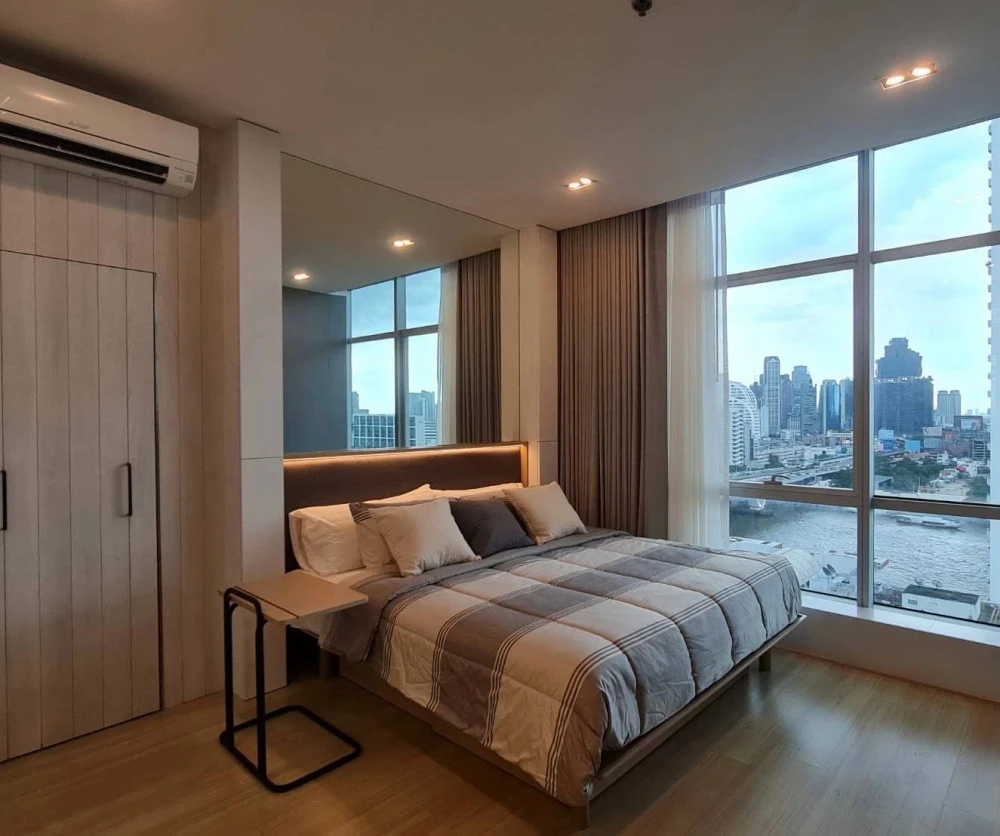 For rent: Sathorn - Chao Phraya house, corner unit with stunning Chao Phraya river bend view, fully furnished with built-in features. Don't miss out!