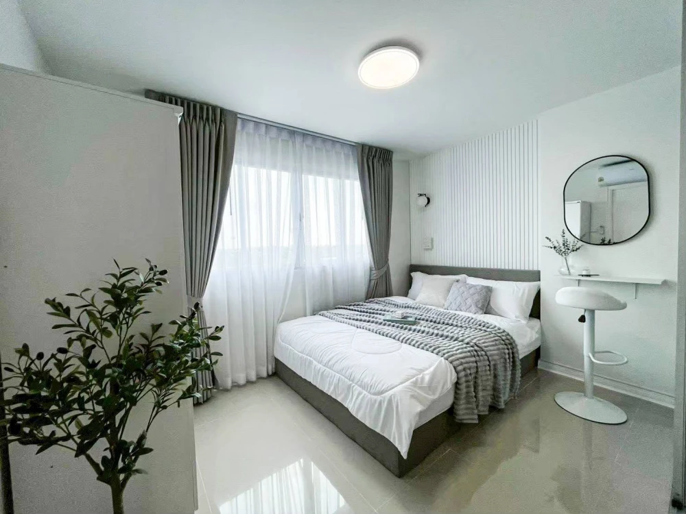 For rent: Lumpini Center Nawamin, minimalist style decoration in white and wood tones. Clean, bright, and airy, creating a comfortable living space.