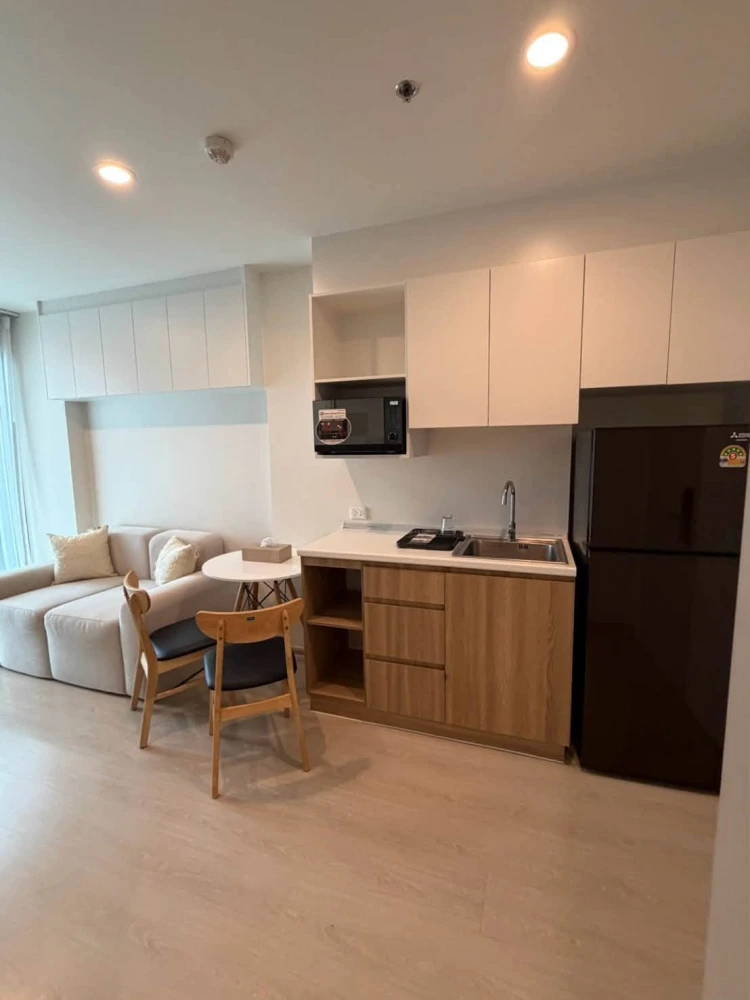 For Sale: Nue Noble Chaengwattana. Unit located near the elevator on the 26th floor, offering high-rise views. Features built-in furnishings and is re