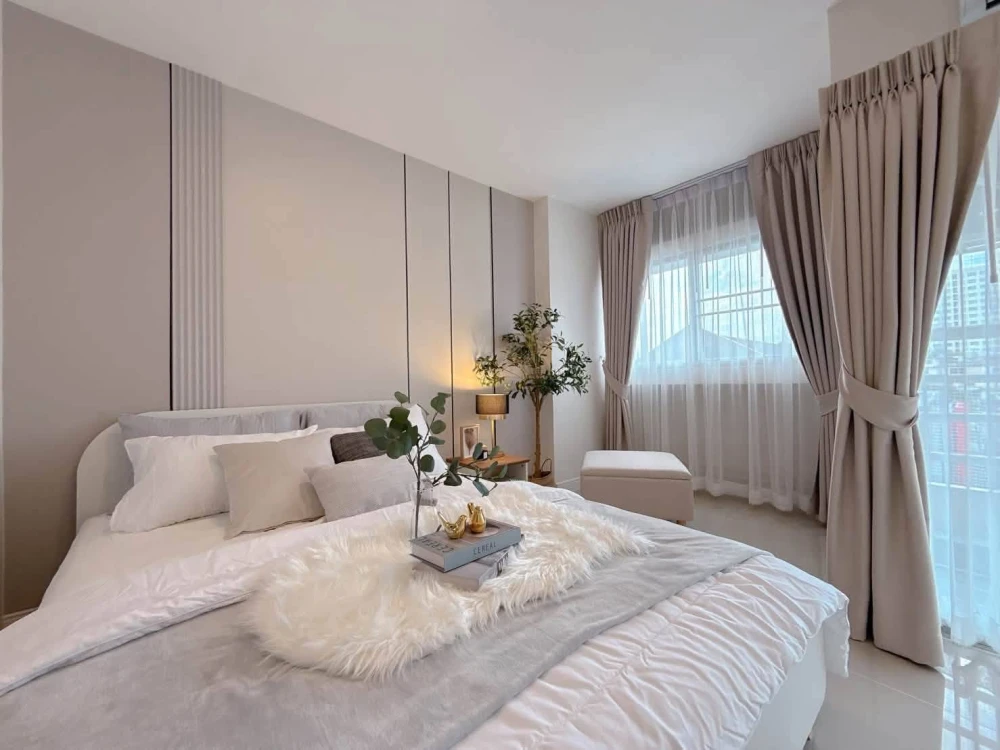 Selling a unit at P. Thana Tower. The room is decorated in a white and cream color scheme, simple, elegant, and warm. It's on the same floor as the sw