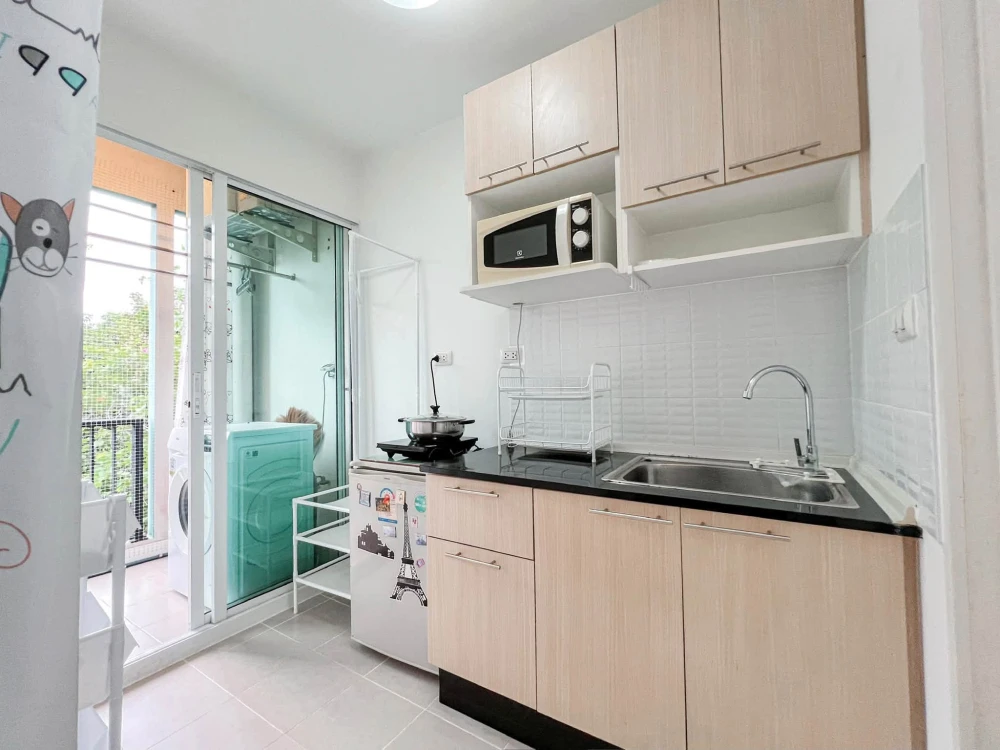 For sale: Studio unit at Unio Charan 3, featuring a partitioned bedroom. Located near the elevator with a garden view and no immediate neighbors—book