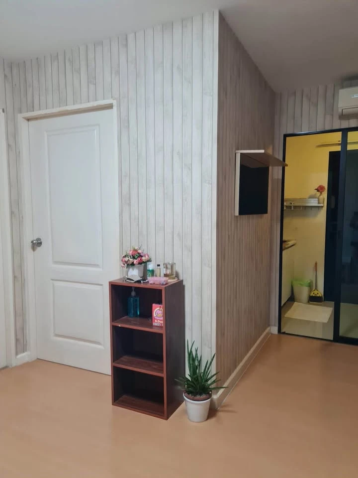 For sale: I-Condo Sukhapiban 2, with wallpaper in a very cool pattern throughout the room. The room is on the 2nd floor, next to the fire exit, defini