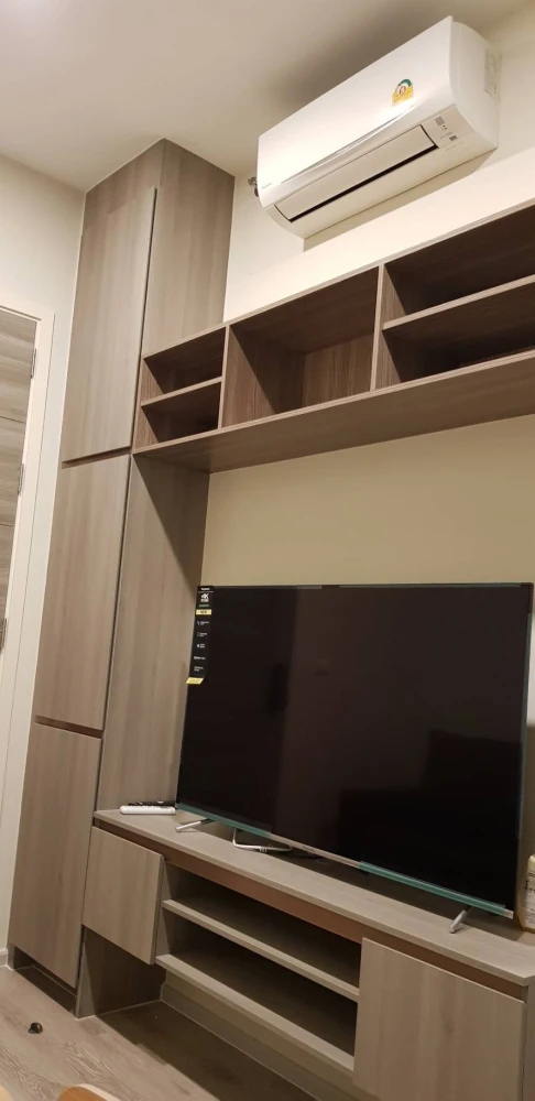 Knightsbridge Collage Ramkhamhaeng for rent, a cozy room with complete electrical appliances and a comfortable brown sofa. Don't miss it!