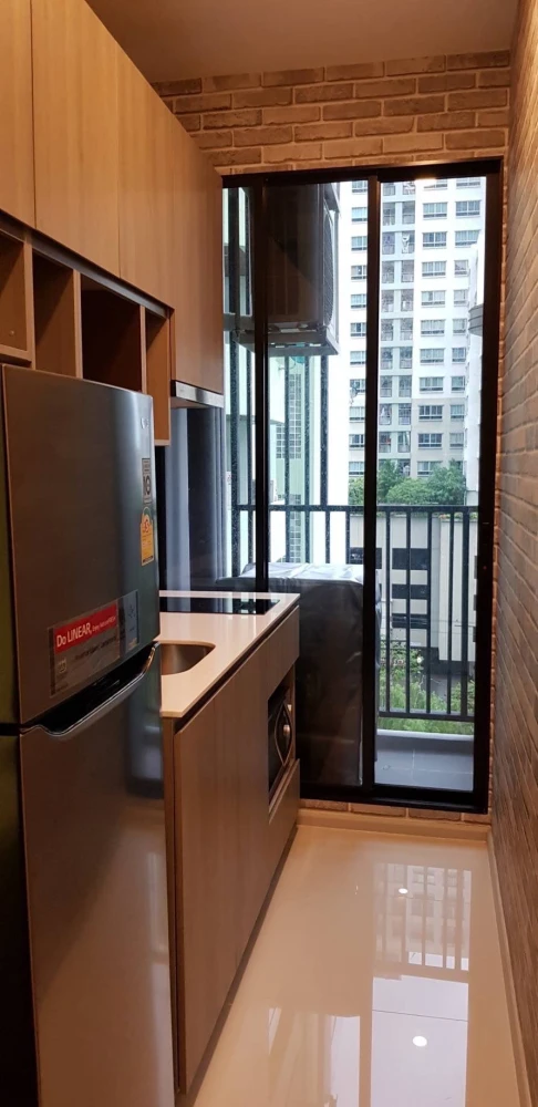 Knightsbridge Collage Ramkhamhaeng for rent, a cozy room with complete electrical appliances and a comfortable brown sofa. Don't miss it!