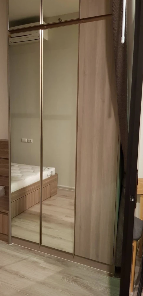 Knightsbridge Collage Ramkhamhaeng for rent, a cozy room with complete electrical appliances and a comfortable brown sofa. Don't miss it!