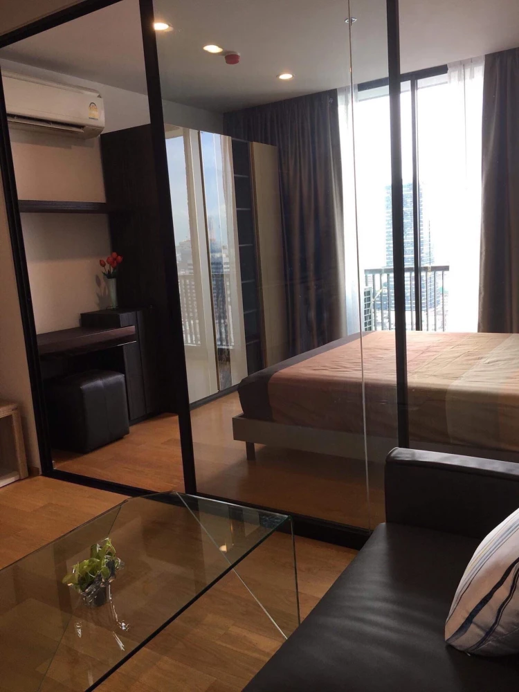 For rent: Noble Revo Silom, very high floor unit, fully furnished and ready to move in. Offers a partial view of the Chao Phraya River. Includes all a