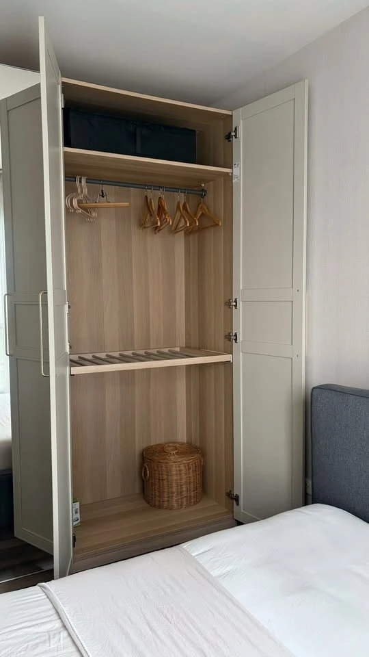 For rent: The Base Park East. The unit features a warm color palette and excellent natural light. From the bedroom, opening the curtains reveals a vie