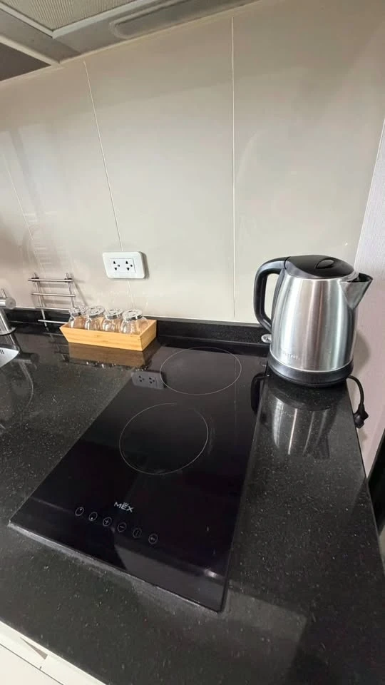 For rent: The Base Park East. The unit features a warm color palette and excellent natural light. From the bedroom, opening the curtains reveals a vie