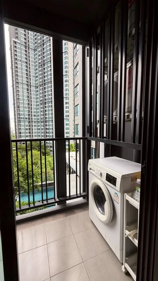 For rent: The Base Park East. The unit features a warm color palette and excellent natural light. From the bedroom, opening the curtains reveals a vie