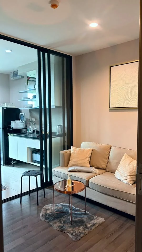 For rent: The Base Park East. The unit features a warm color palette and excellent natural light. From the bedroom, opening the curtains reveals a vie