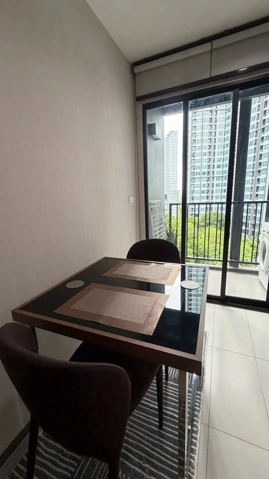 For rent: The Base Park East. The unit features a warm color palette and excellent natural light. From the bedroom, opening the curtains reveals a vie