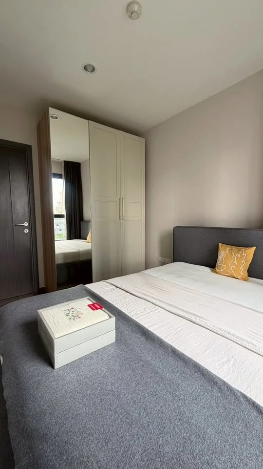 For rent: The Base Park East. The unit features a warm color palette and excellent natural light. From the bedroom, opening the curtains reveals a vie