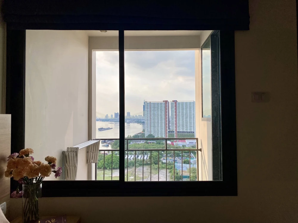 For rent: U Delight Residence Riverfront Rama 3, 23rd floor unit with balcony overlooking the Chao Phraya River. The room is bright, airy, and comfort