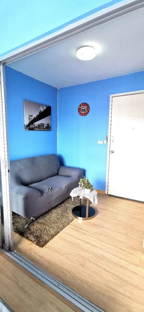 For Rent: Plum Condo Bangyai Station (Phase 1). Bright blue-themed unit on the top floor with a beautiful view. The room is shielded from direct sunli