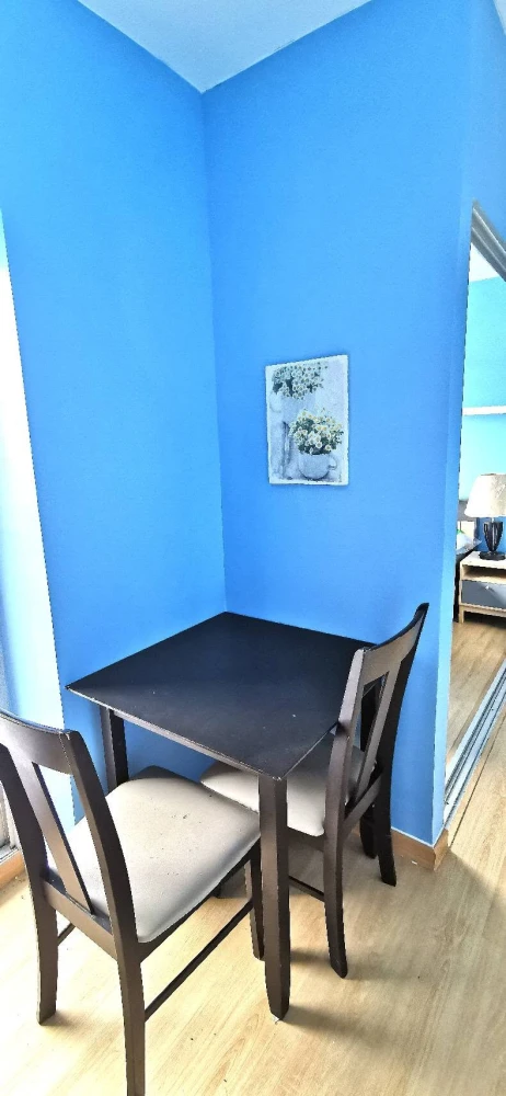 For Rent: Plum Condo Bangyai Station (Phase 1). Bright blue-themed unit on the top floor with a beautiful view. The room is shielded from direct sunli