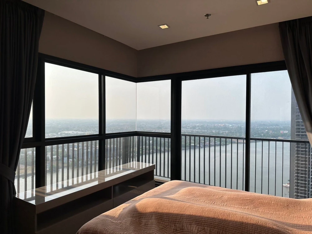 Condo for rent at Politan Rive, corner unit overlooking the Chao Phraya River, 31st floor, fully furnished. Book now!
