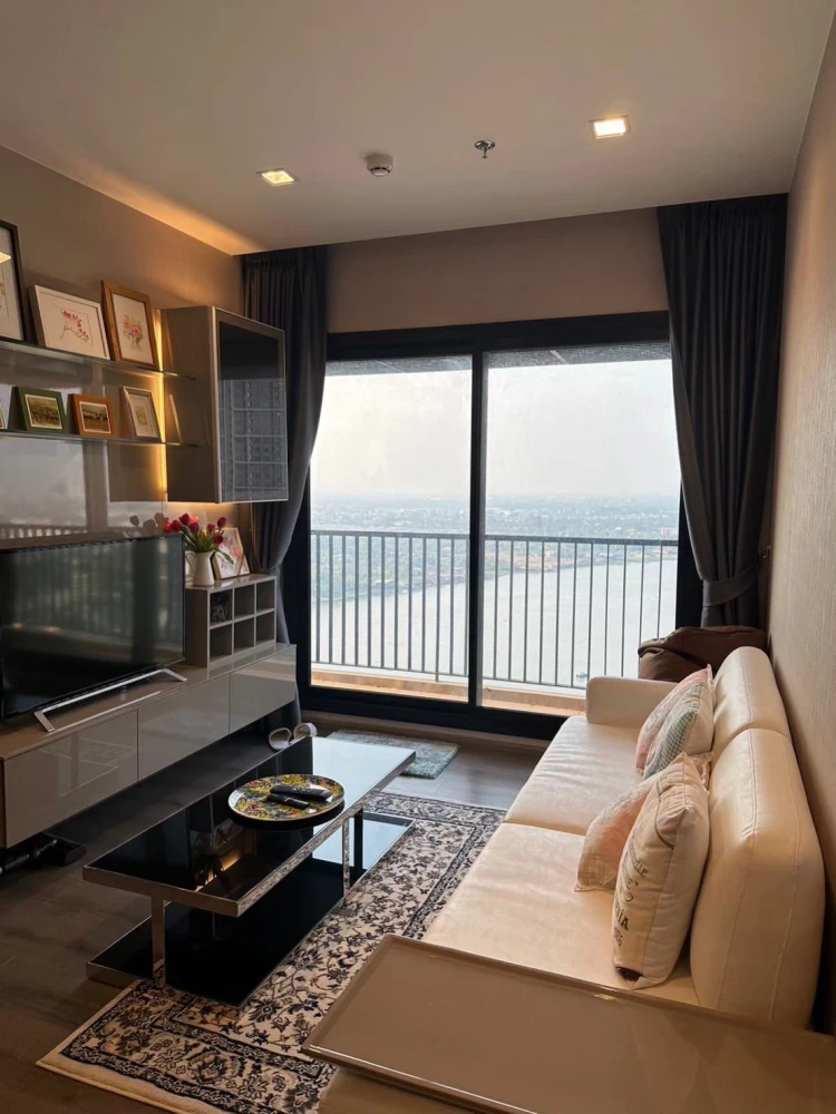 Condo for rent at Politan Rive, corner unit overlooking the Chao Phraya River, 31st floor, fully furnished. Book now!