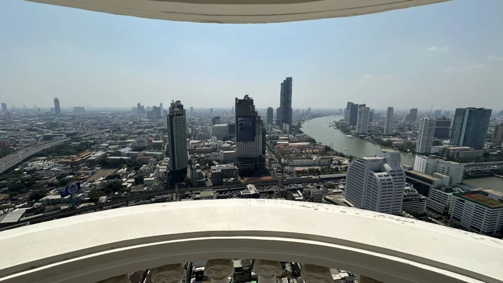 Condo for rent at State Tower Silom. Large and comfortable unit with ample living space on the 42nd floor, offering stunning Chao Phraya River views.