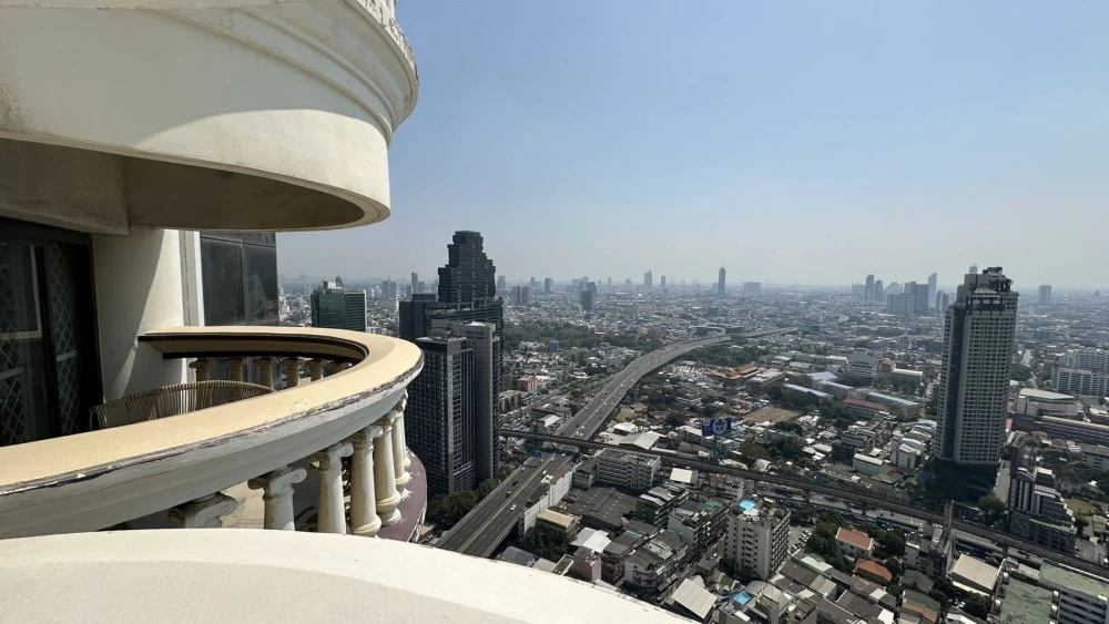 Condo for rent at State Tower Silom. Large and comfortable unit with ample living space on the 42nd floor, offering stunning Chao Phraya River views.